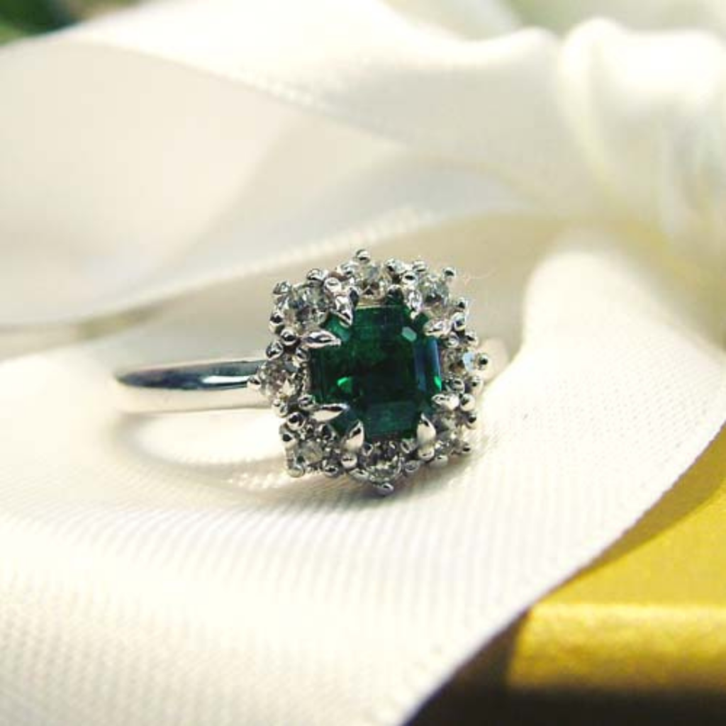 Transformed into a custom emerald engagement ring reset before and after