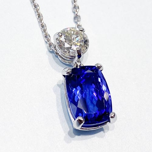 Diamond from mom's engagement ring reset into tanzanite and diamond pendant before and after