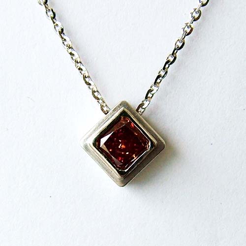 Square red gemstone pendant in a custom silver setting.