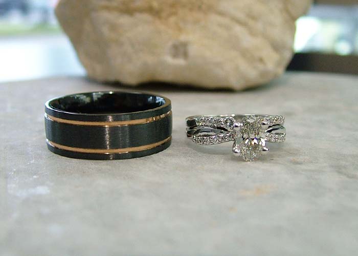 Alternative metal custom men’s engagement ring in black tungsten with gold inlay.