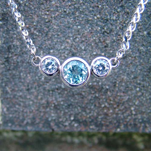 Custom necklace featuring blue and white lab-grown diamonds in a delicate silver chain.