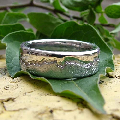 Custom men’s engagement ring in textured white gold with a nature-inspired finish.