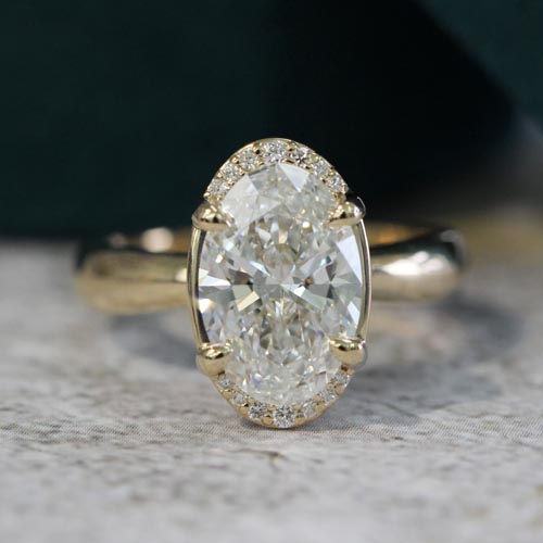 Oval solitaire diamond ring in yellow gold, the most popular engagement ring style for timeless elegance.